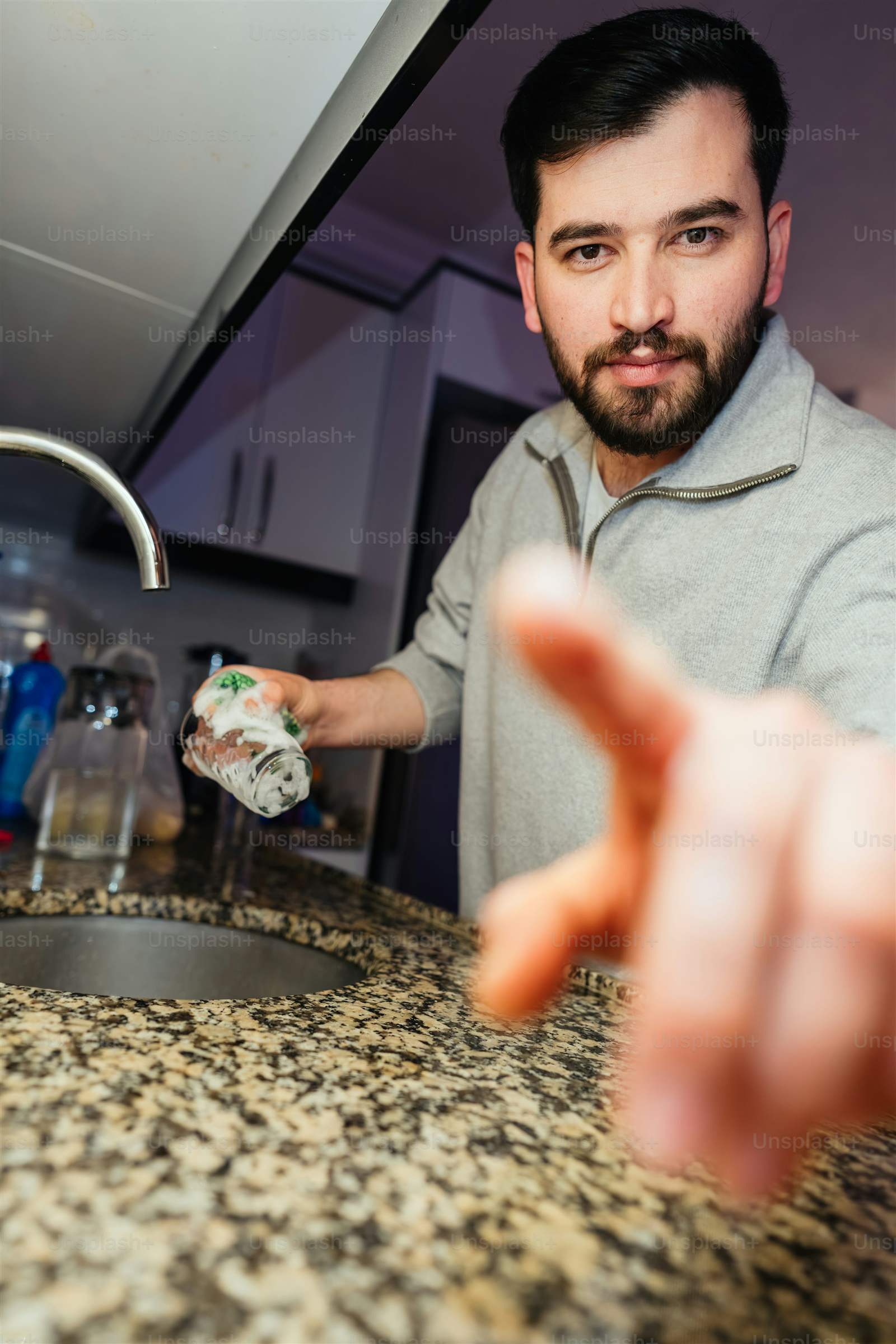A person quickly wiping down a kitchen counter after cooking