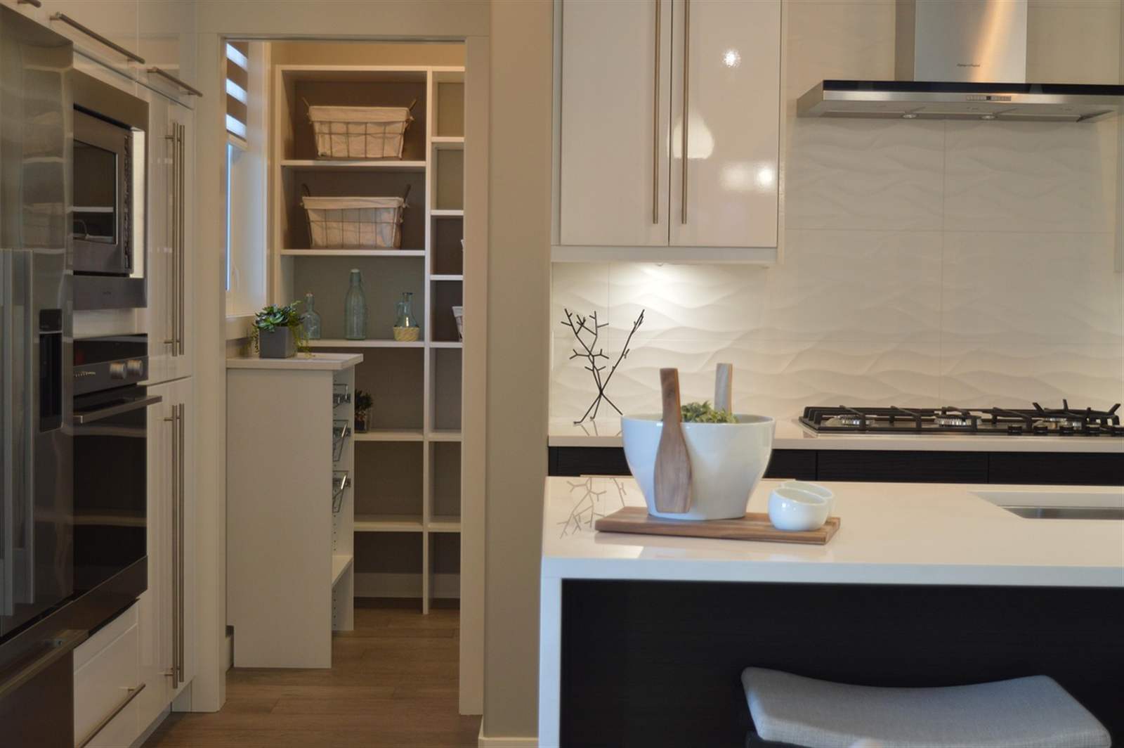 An organized home kitchen pantry with labeled shelving