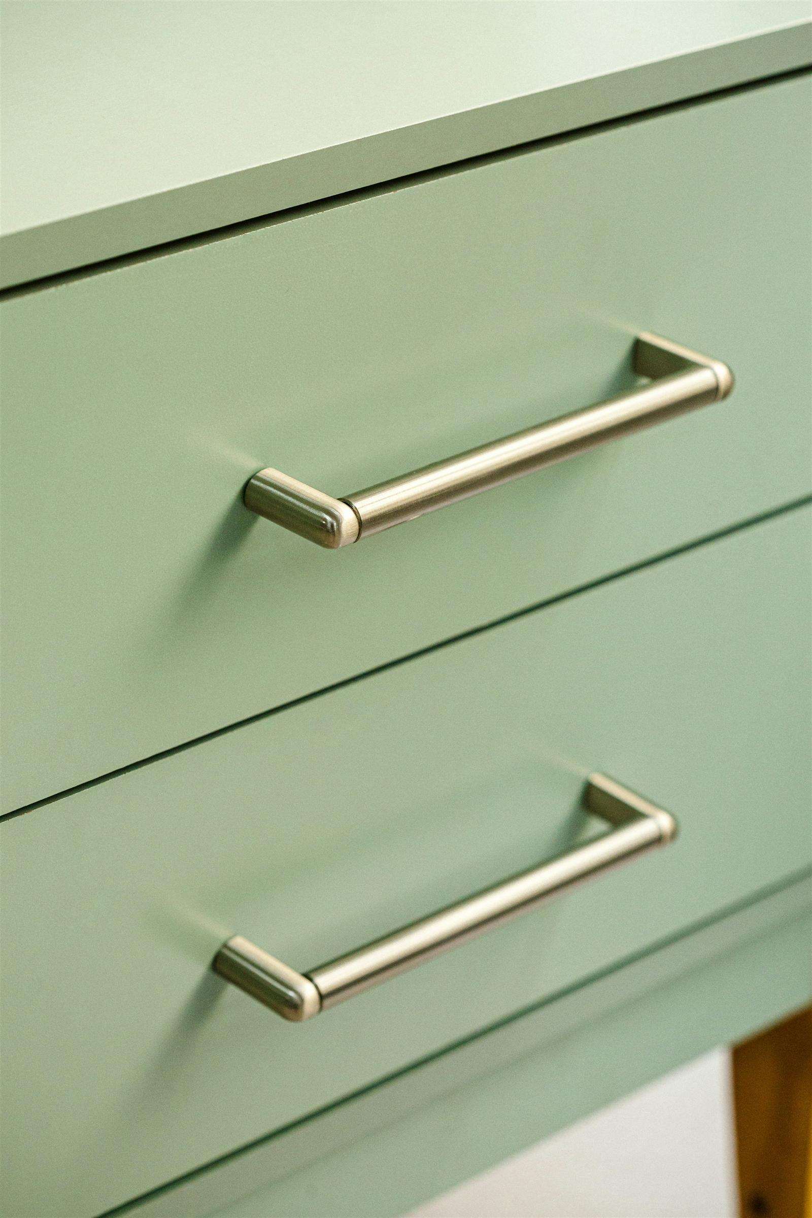 Close-up of a drawer front with two bar-style pulls mounted symmetrically