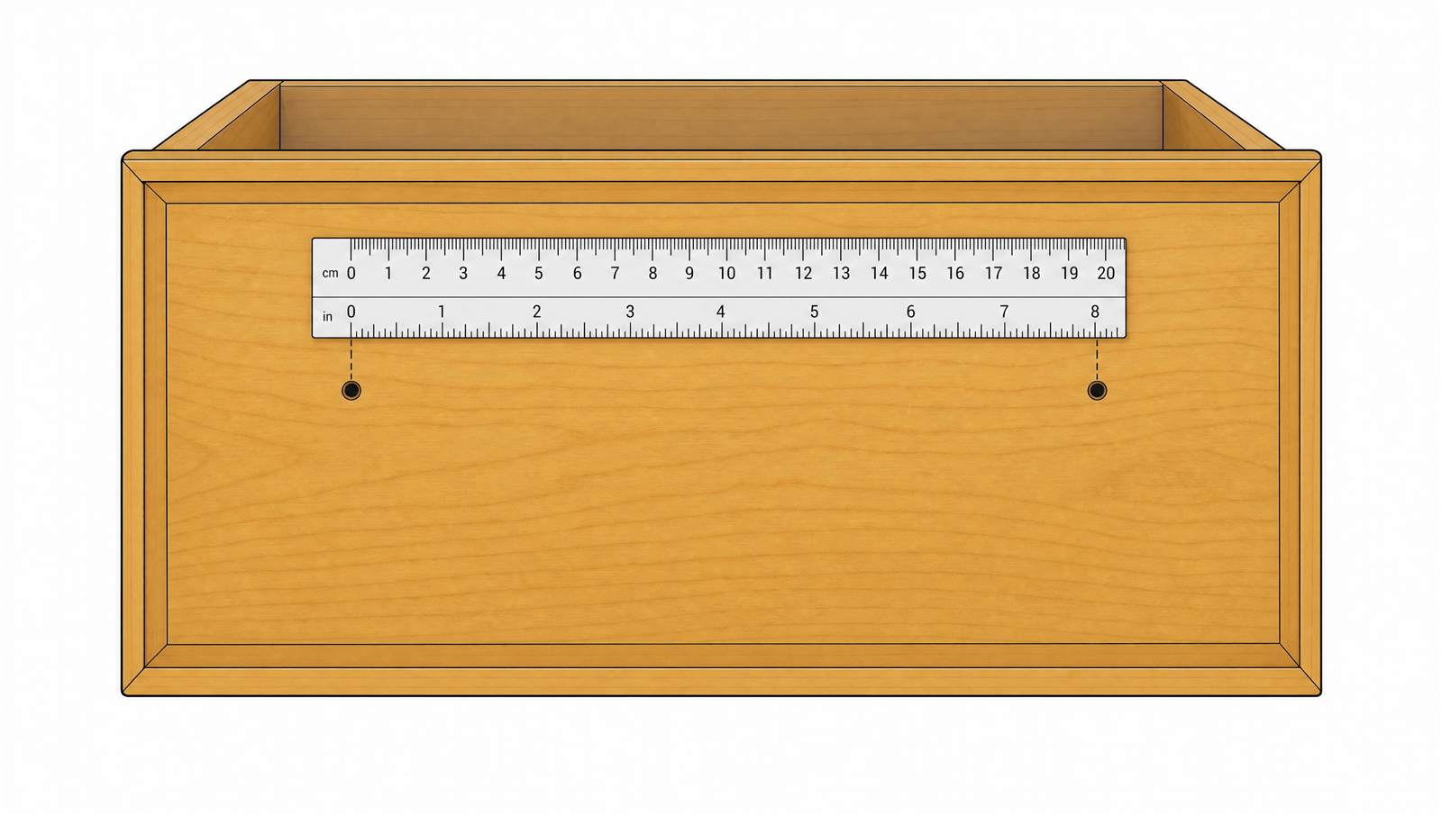 Top-down view of a drawer front with a ruler measuring the distance between two screw holes