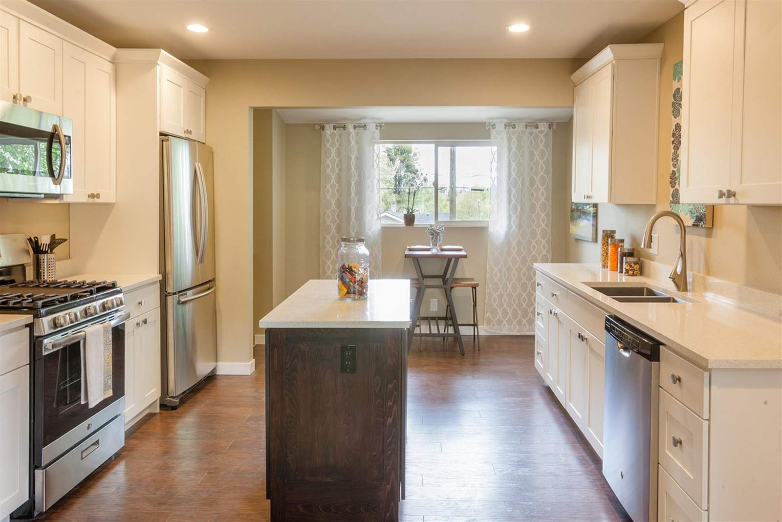 Close-up of white kitchen cabinets with granite countertop and subway tile backsplash
