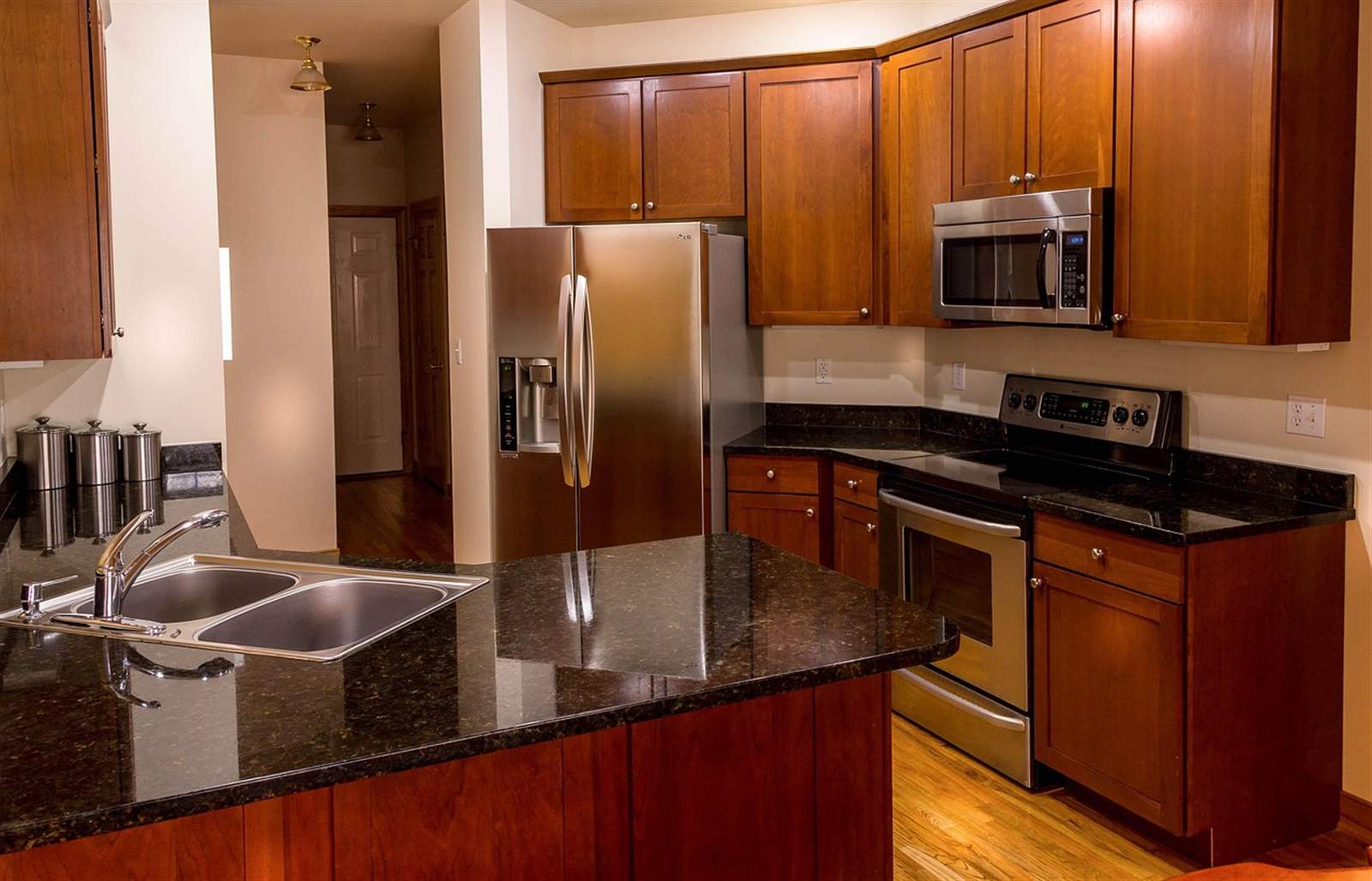Kitchen cabinets and granite countertop with sink base cabinet, showing cabinet-to-countertop proportions