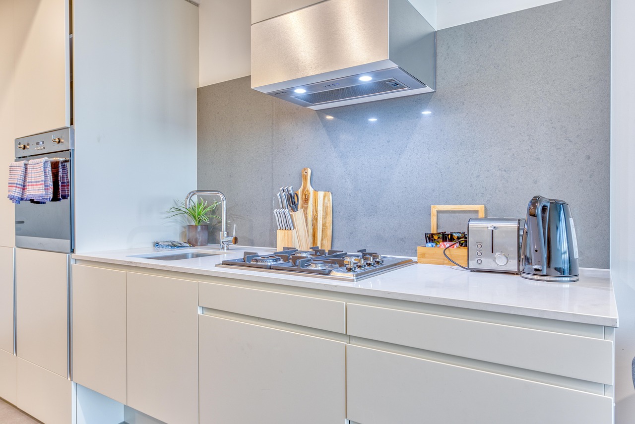 Sleek small apartment kitchen with streamlined cabinetry and appliances
