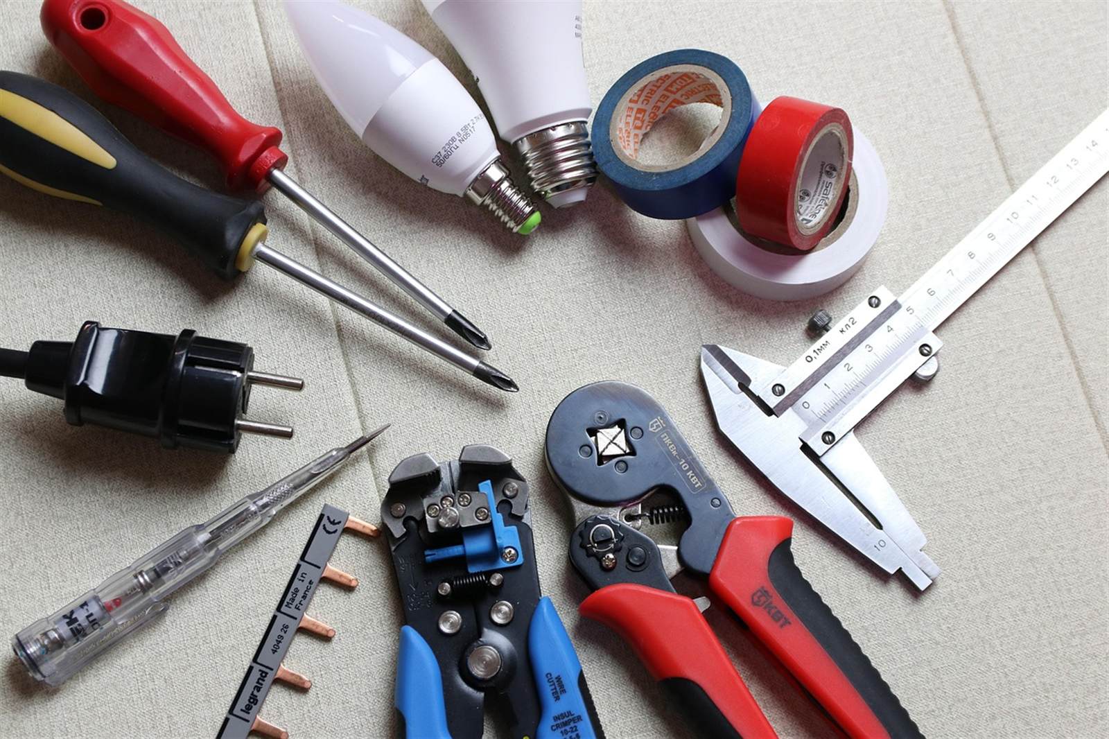 An electrician's hands connecting and routing wiring during an installation